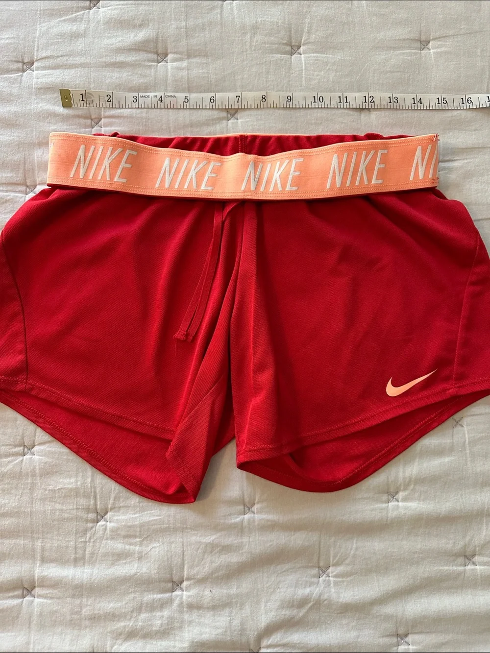 Nike Red Women's Athletic Running Shorts with peach Swoosh